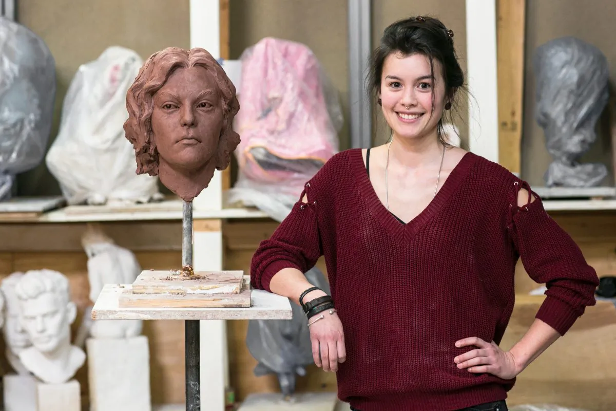 Zoe Dufour with one of her sculptures in progress at the Grand Central Atelier in Queens, New York, on April 14, 2016. (Benajmin Chasteen/Epoch Times)