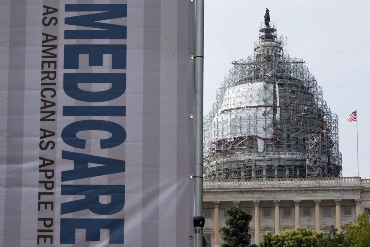A sign supporting Medicare is seen on Capitol Hill in Washington, D.C., on July 30, 2015, as registered nurses and other community leaders celebrate the 50th anniversary of Medicare and Medicaid. Medicare spending on breakthrough medications for hepatitis C will nearly double in 2015, passing $9 billion, according to new government figures. That’s raising insurance costs for all beneficiaries, whether or not they have the liver-wasting viral disease. (AP Photo/Jacquelyn Martin)