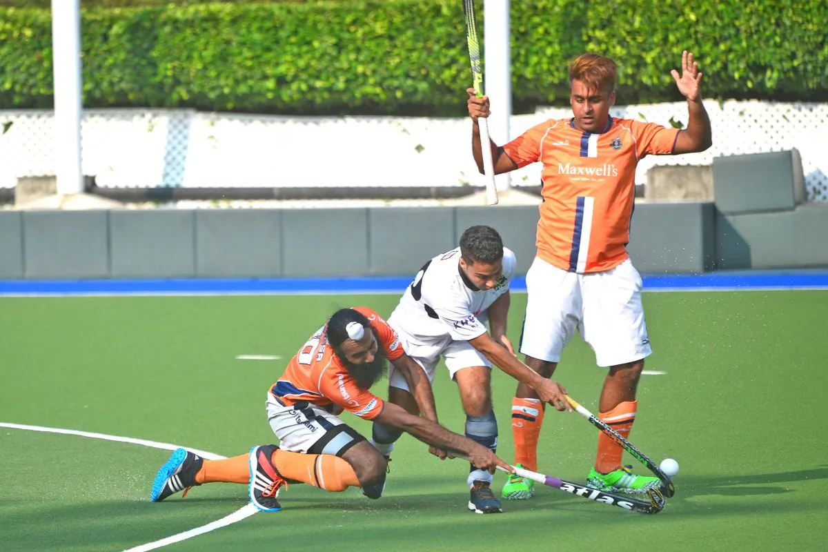 Khalsa-A’s Ari Ali (far right) and Harsmarjit Singh keep SSSC-A’s Kulvinder Singh at bay in their Holland Cup final at King's Park on Sunday May 15, 2016. (Eddie So)