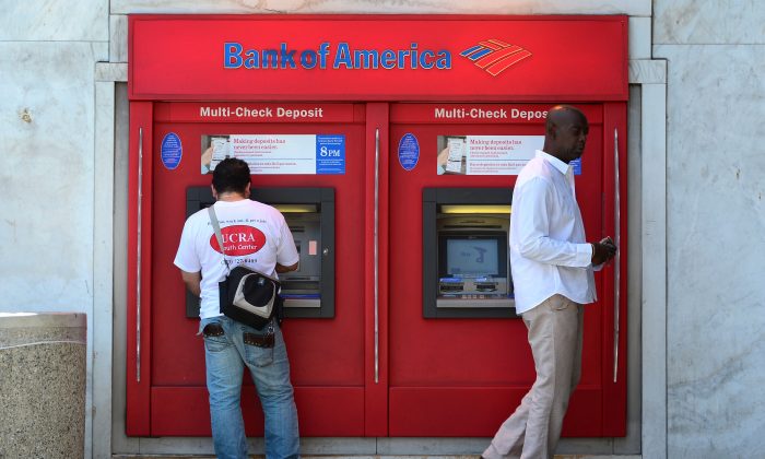 Bank customers use an ATM in Hollywood, Calif., on July 20, 2012. (Frederic J. Brown/AFP/GettyImages)