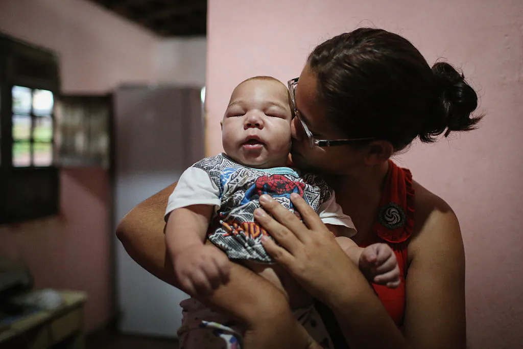 David Henrique Ferreira, 5 months, who was born with microcephaly, is kissed by his mother Mylene Helena Ferreira on January 29, 2016 in Recife, Pernambuco state, Brazil. (Mario Tama/Getty Images)