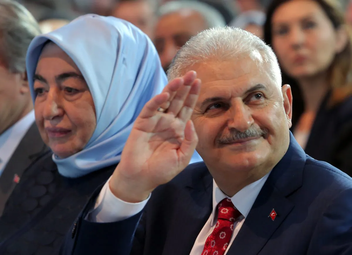 Binali Yildirim, Turkey's current Transportation Minister and founding member of the AKP, Turkey’s governing party, and his wife Semiha Yildirim salute supporters during party congress in Ankara, Turkey, on May 22, 2016. Turkey's ruling party held a special convention on Sunday to confirm Binali Yildirim, a longtime ally of President Recep Tayyip Erdogan as its new chairman and next prime minister, a move that is likely to consolidate the Turkish leader's hold on power. (AP Photo/Riza Ozel)