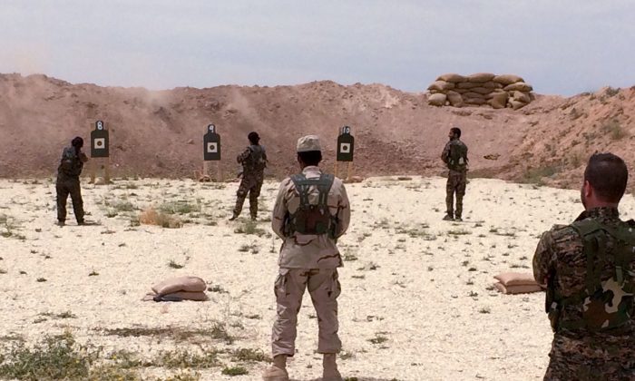 Syrian Arab trainees practice firing their small arms at an undisclosed training range in northern Syria on May 21, 2016. (AP Photo/Robert Burns)