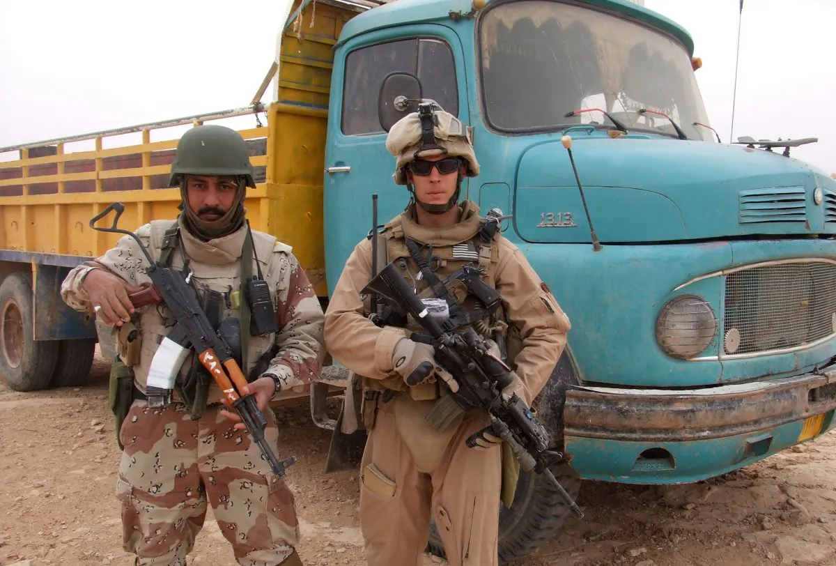 Chase Millsap with the Captain standing next to a suspected truck bomb following a successful raid in Al Anbar, Iraq. (Chase Millsap via AP)