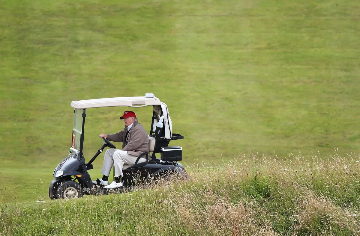 In this July 31, 2015 file photo, Republican presidential candidate Donald Trump drives his golf buggy during the second day of the Women's British Open golf championship on the Turnberry golf course in Turnberry, Scotland. (AP Photo/Scott Heppell)