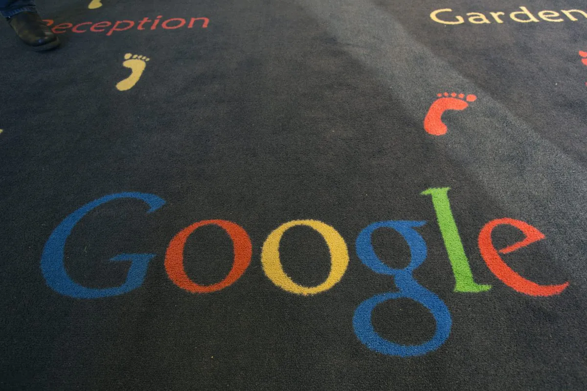 FILE -  This Tuesday, Dec. 10, 2013 file photo shows the Google logo printed on a carpet during the inauguration of the new Google cultural institute in Paris, France. French police have raided Google's Paris offices as part of an investigation into "aggravated tax fraud" and money laundering, authorities said Tuesday. (AP Photo/Jacques Brinon, File)