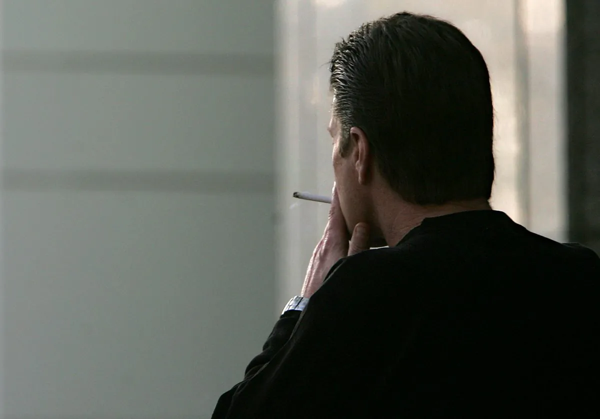 A man smokes a cigarette in Sacramento, Calif., in a Dec. 13, 2005 file photo. (Rich Pedroncelli/AP Photo)