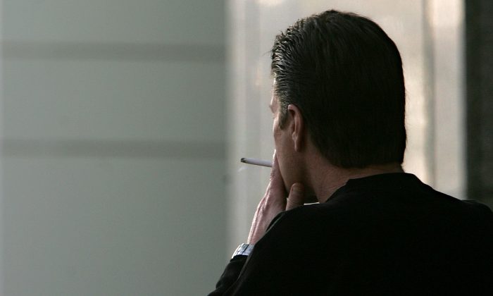 A man smokes a cigarette in Sacramento, Calif., in a Dec. 13, 2005 file photo. (Rich Pedroncelli/AP Photo)