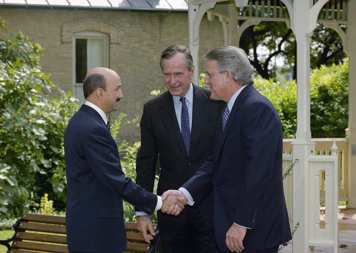 Mexican President Carlos Salinas de Gortari (L) greets then-Prime Minister Brian Mulroney and U.S. President George Bush on Oct. 7, 1992 in San Antonio, Texas. The leaders met to initial the North American Free Trade Agreement, which may be renegotiated depending on who becomes the next U.S. president. (AP Photo/Marcy Nighswander)