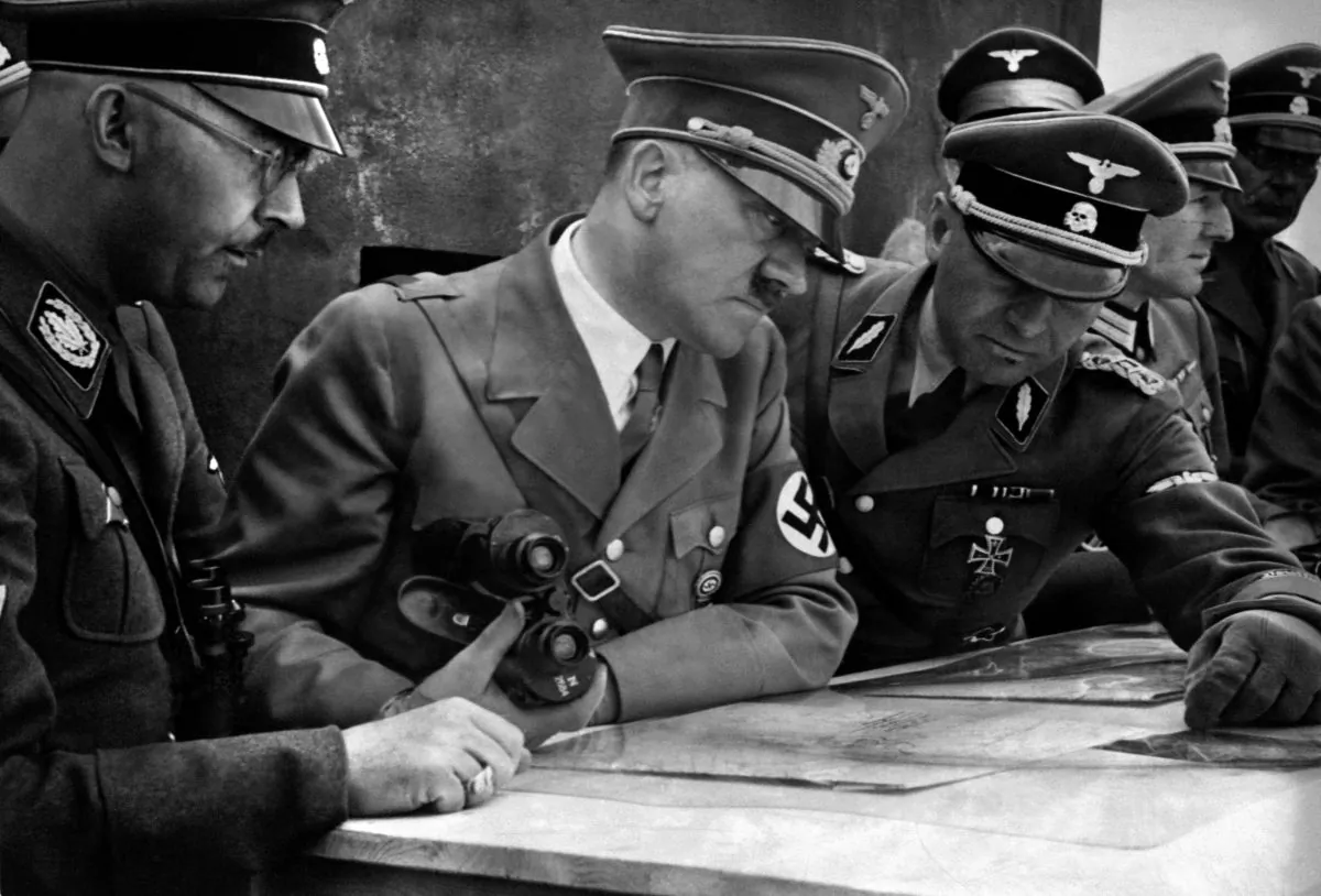 A picture dated 1939 shows German Nazi Chancellor and dictator Adolf Hitler (C) consulting a geographical survey map with his general staff. (AFP/Getty Images)