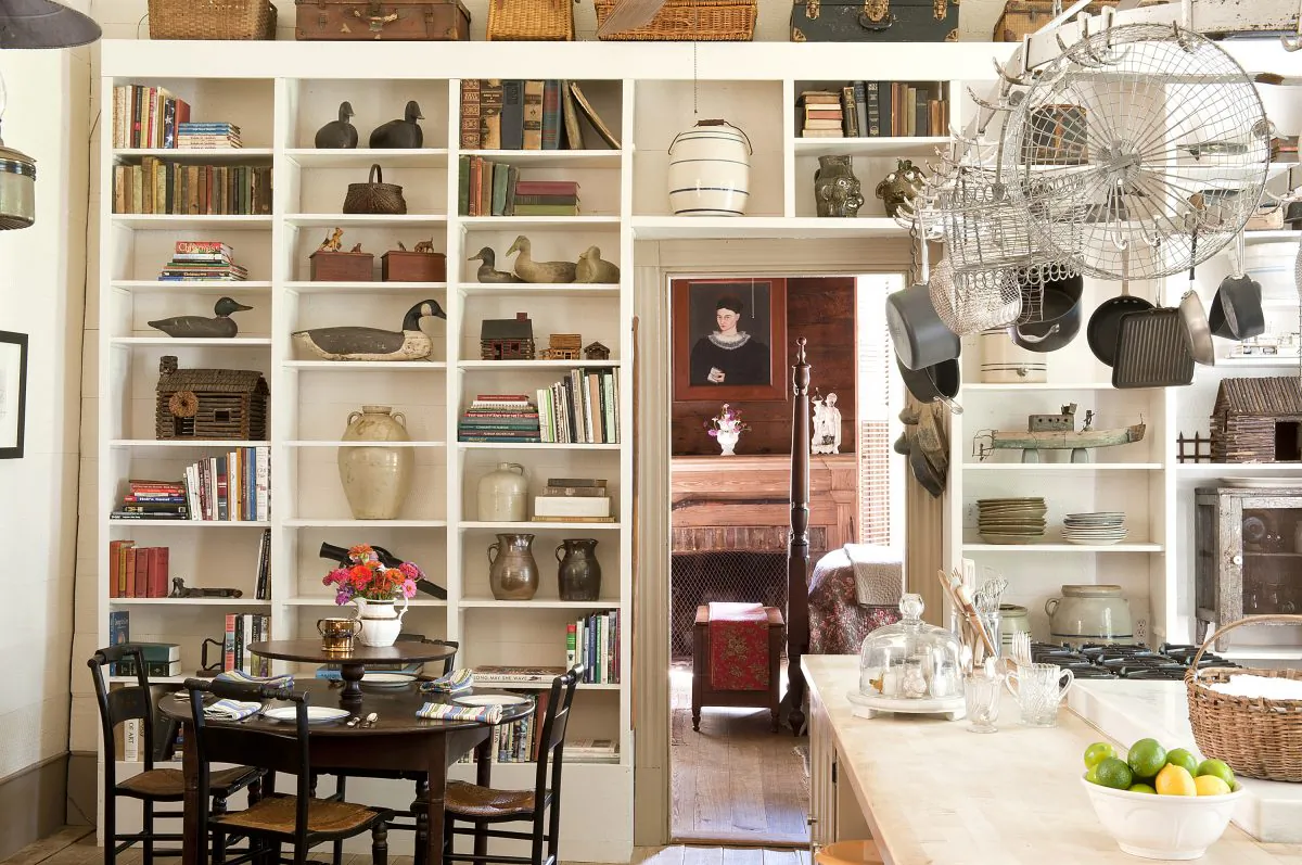 Antiques fill kitchen shelving in an 1850’s Alabama farmhouse. (Susan Sully/The Monacelli Press via AP)