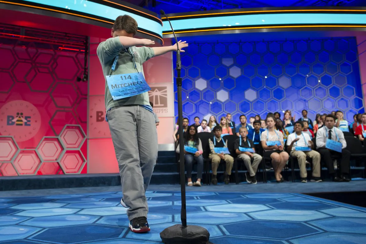 Mitchell Robson, 14, of Danvers, Mass., steps backwards while celebrating correctly spelling his word during the preliminary round three of the Scripps National Spelling Bee in National Harbor, Md., Wednesday, May 25, 2016. (AP Photo/Cliff Owen)