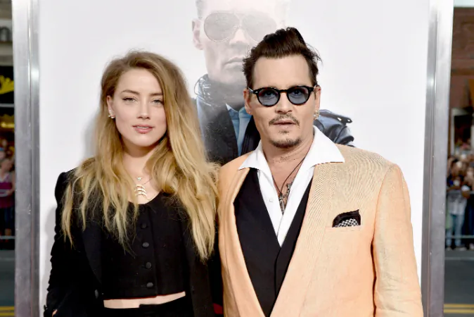 Actors Amber Heard (L) and Johnny Depp attend the 'Black Mass' Boston special screening at the Coolidge Corner Theatre, in Boston, Mass., on Sept. 15, 2015. (Paul Marotta/Getty Images for Warner Brothers)