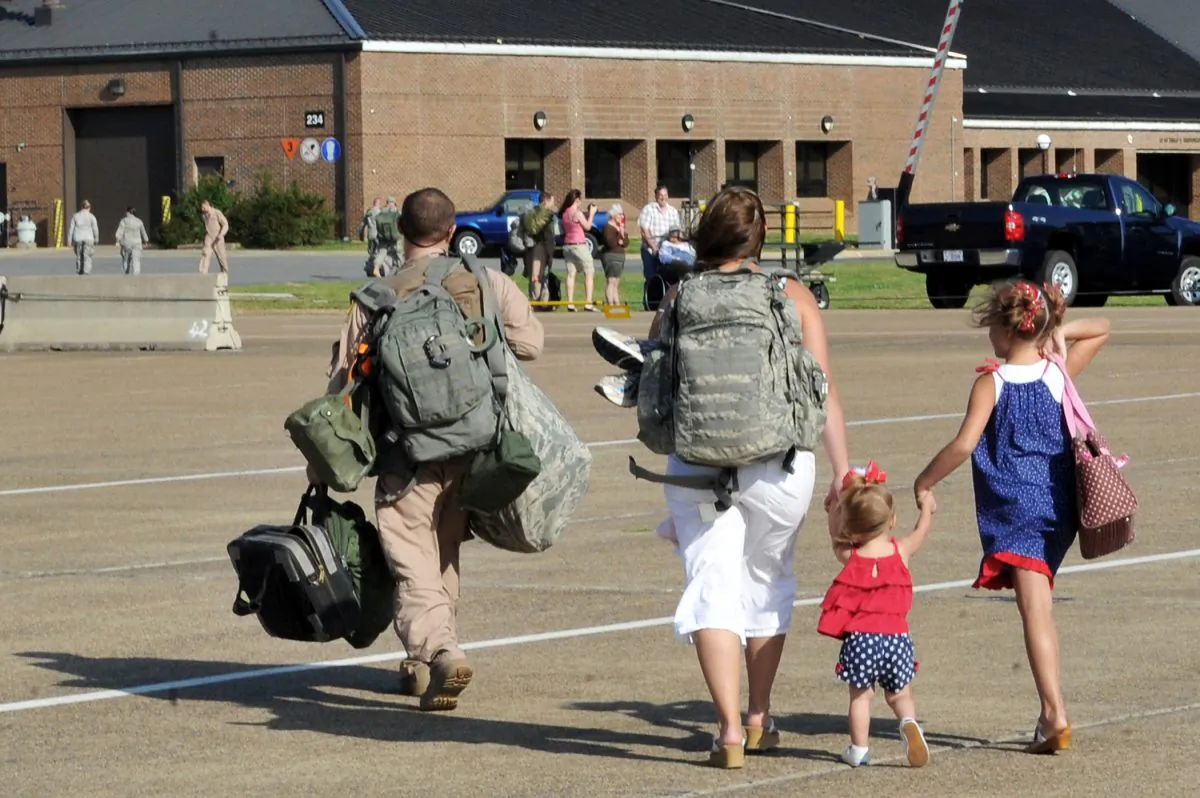Staff Sgt. John Carlin walks off the flightline with his family May 13, 2001, at Little Rock Air Force Base, Ark. Sergeant Carlin is assigned to the 61st Airlift Squadron. (U.S. Air Force photo/Staff Sgt. Chris Willis)