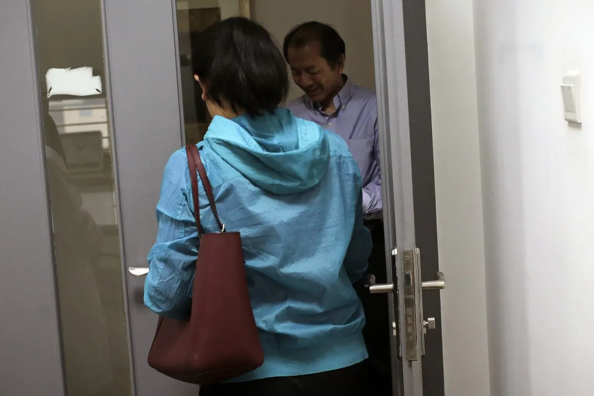Chen Yun (Front) walks past Dr. Liu Jiaen (Rear) as she arrives for vitro fertilization (IVF) treatment at a hospital in Beijing on April 24, 2016. China’s decision to allow  married couples to have two children is driving a surge in demand for fertility treatments. (Andy Wong/AP)