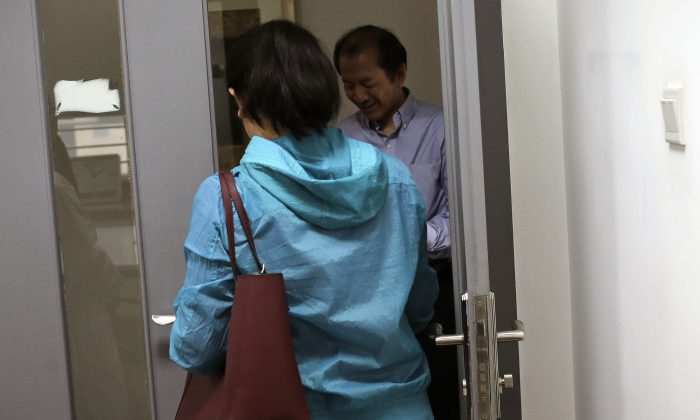 Chen Yun (Front) walks past Dr. Liu Jiaen (Rear) as she arrives for vitro fertilization (IVF) treatment at a hospital in Beijing on April 24, 2016. China’s decision to allow  married couples to have two children is driving a surge in demand for fertility treatments. (Andy Wong/AP)