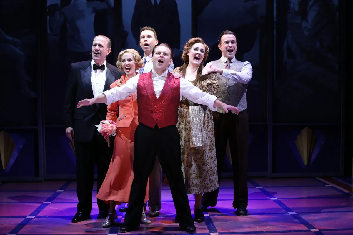 Robert Creighton, center, as James Cagney, with his supporting cast, (L--R) Bruce Sabath, Ellen Zolezzi, Jeremy Benton, Danette Holden and Josh Walden, in “Cagney: The Musical." (Carol Rosegg)