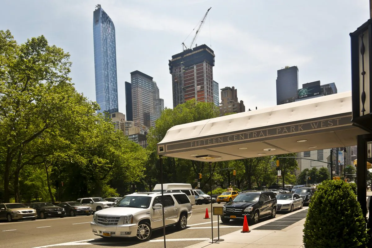 A luxury 90-floor apartment skyscraper called "One57," left, rises above all other buildings overlooking Central Park, while a crane sits atop ongoing construction for a new condominium skyscraper at 220 Central Park South, Thursday May 26, 2016, in New York. A penthouse in One57 went for $100.5 million in 2014, but an apartment in the new condominium is expected to sell for $250 million. (AP Photo/Bebeto Matthews)