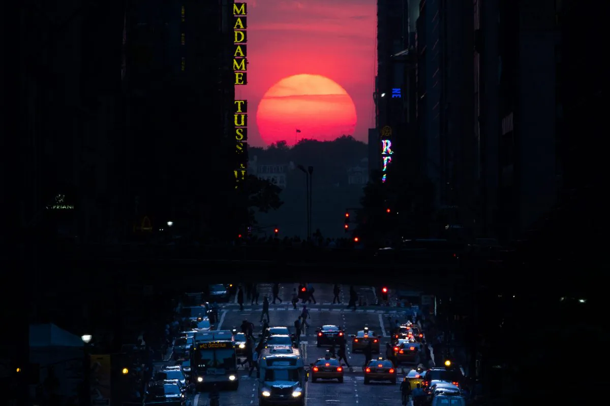 The sun sets along 42nd Street in Manhattan during an annual phenomenon known as "Manhattanhenge," when the sun aligns perfectly with the city's transit grod, Wednesday, May 29, 2013, in New York. (AP Photo/John Minchillo)