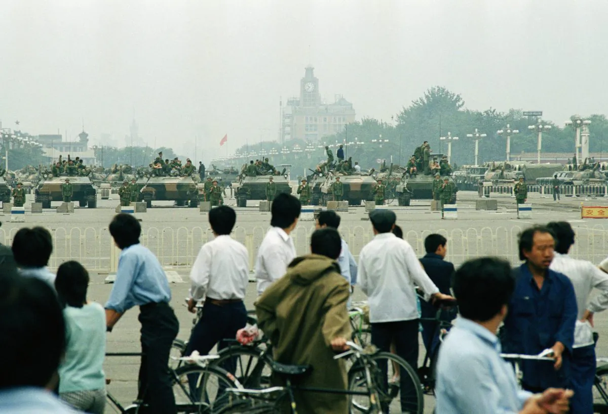 Crowds of Beijing residents watch the military block access to Tiananmen Square in Beijing on June 7, 1989. (AP Photo/Sadayuki Mikami)