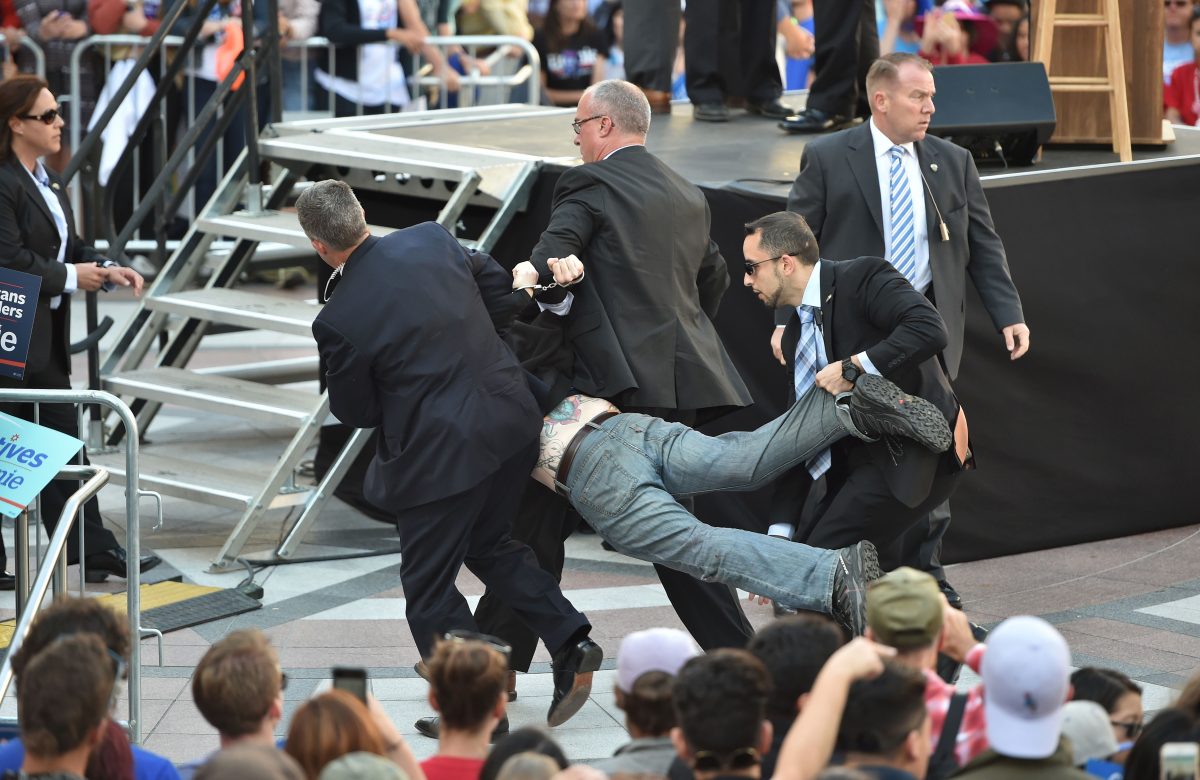 Secret Service agents arrest a man for climbing over a barricade and approaching Democratic presidential candidate Bernie Sanders while he speaks at Frank Ogawa Plaza in Oakland, California on May 30, 2016. (Josh Edelson/AFP/Getty Images)