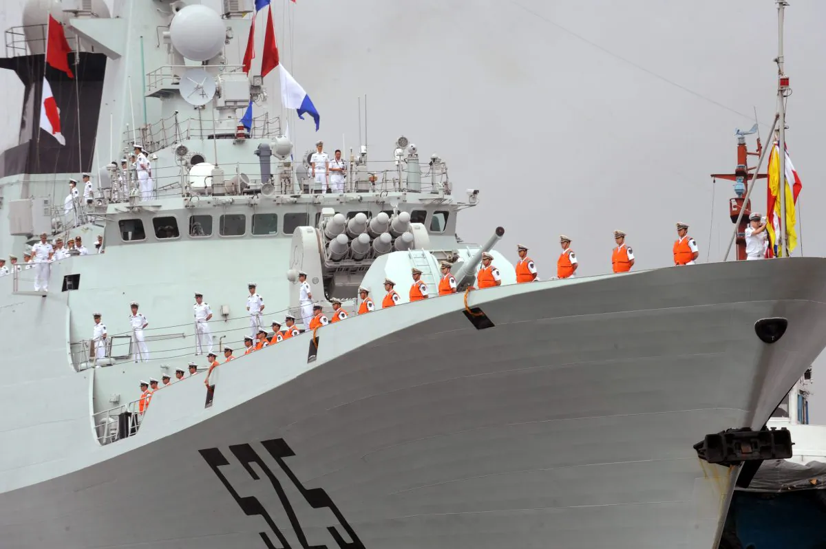 People's Liberation Army (PLA) Navy sailors stand on the deck of a Chinese warship at the international port in Manila on April 13, 2010. (Ted Aljibe/AFP/Getty Images)