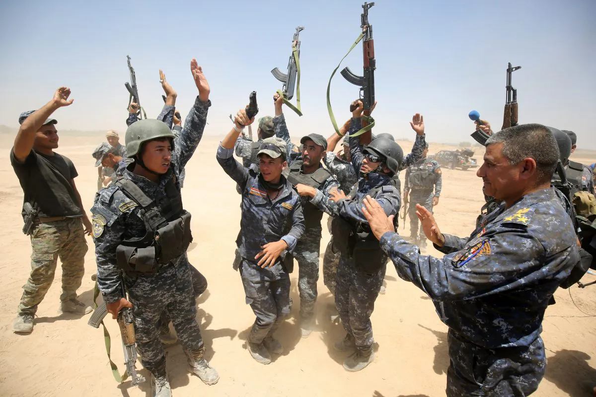Pro-government forces fighters celebrate in the al-Sejar village, in Iraq's Anbar Province, on May 27, 2016, as they take part in a major assault to retake the city of Fallujah from the Islamic State. (Ahmad al-Rubayed/AFP/Getty Images)