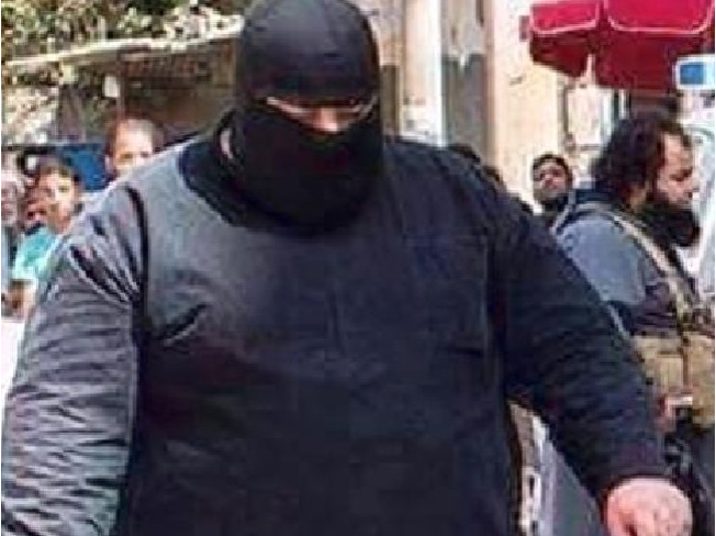 Pictured here, "Bulldozer," has been known to cut off the limbs of children and behead hooded men in front of large crowds. (British Channel 4/YouTube)