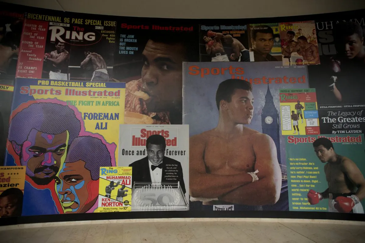 Large posters of mostly Sports Illustrated magazine covers are displayed at the "I Am The Greatest, Muhammad Ali" exhibition at the O2 arena, which hosts high profile boxing fights in London, Saturday, June 4, 2016. Ali, the magnificent heavyweight champion whose fast fists and irrepressible personality transcended sports and captivated the world, died according to a statement released Friday by his family. He was 74. (AP Photo/Matt Dunham)