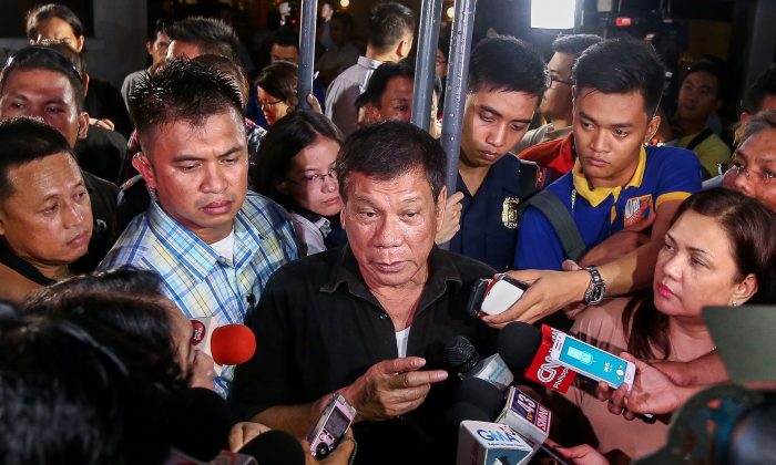 Philippine President Rodrigo Duterte (C) speaks to journalists in Davao City on June 2, 2016. (Manman Dejeto/AFP/Getty Images)