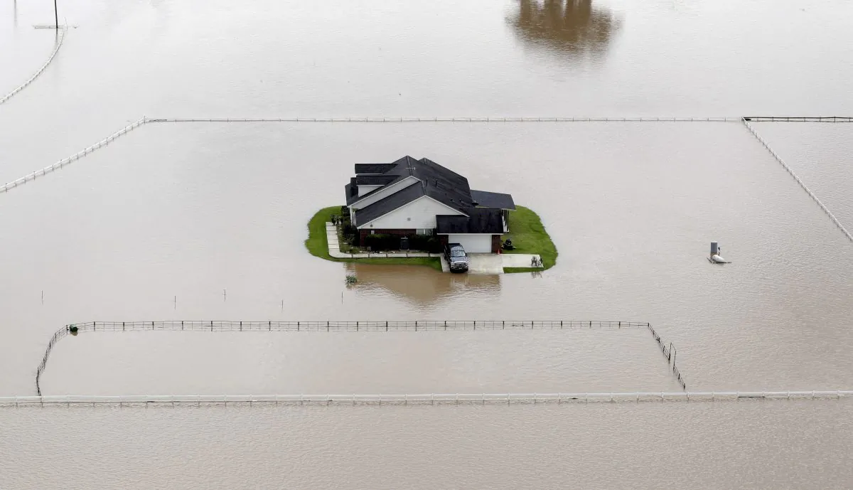 A home surrounded by floodwaters is shown in this aerial view, in Rosharon, Texas, on June 4, 2016. Parts of Texas have been inundated with rain in the last week, and more than half of the state has been under flood watches or warnings. (AP Photo/David J. Phillip)