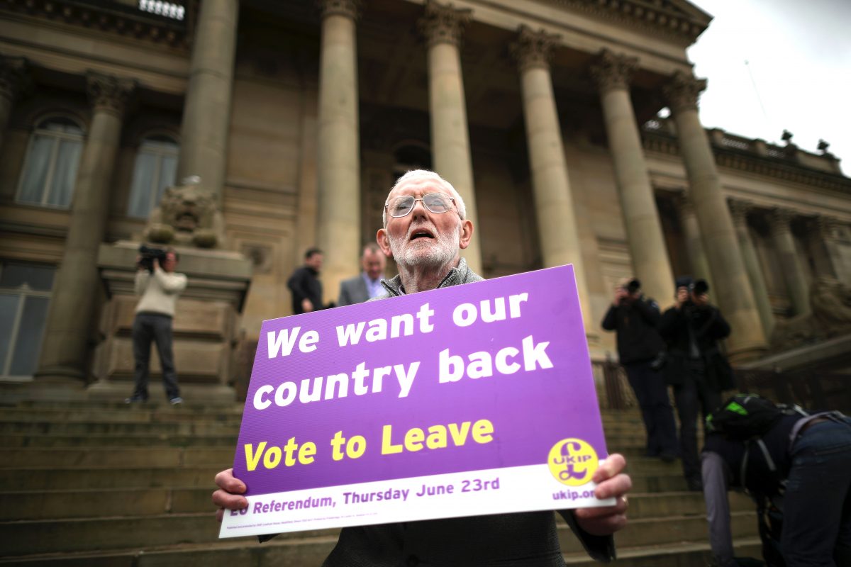 A "Vote to Leave" campaigner holds a placard as Leader of the United Kingdom Independence Party (UKIP), Nigel Farage, campaigns for votes to leave the European Union in the June 23rd referendum in Bolton, England, on May 25, 2016. (Christopher Furlong/Getty Images)