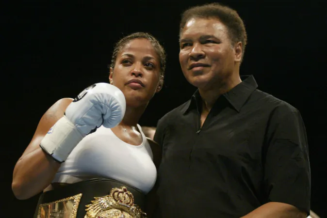 Female boxer Laila Ali poses with her father, former boxer, Muhammad Ali, after defeating Suzy Taylor after two rounds at the Aladdin Casino on August 17, 2002 in Las Vegas, Nevada. (Scott Halleran/Getty Images)
