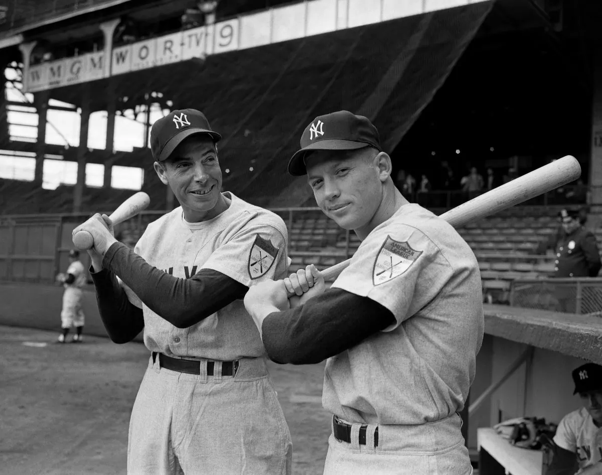 Joe DiMaggio (L) Yankees' star centerfielder, and rookie Mickey Mantle shoulder bats at Ebbets Field in Brooklyn, April 14, 1951, as the New York Yankees met the Brooklyn Dodgers in a short exhibition series that marked Mantle's New York debut. (AP Photo) 