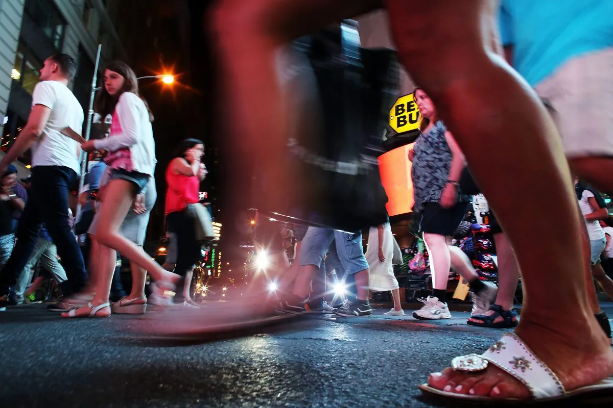 NEW YORK, NY - AUGUST 19: People walk through Times Square on August 19, 2015 in New York City. As the iconic Times Square continues to draw tourists with its entertaining and carnival like atmosphere, New York Mayor Bill de Blasio has announced that the city is preparing to address the issue of topless and painted women who pose for pictures while soliciting tips. In recent years Times Square has seen an influx of performers who dress in a variety of costumes and sometimes become aggressive with the public. The semi-nude women, who call themselves desnudas, Spanish for naked, and pose for photos in exchange for tips, are a new addition to the colourful environment. (Photo by Spencer Platt/Getty Images)