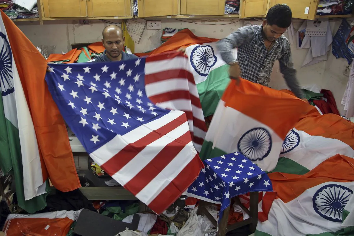 An Indian men fold the U.S. and Indian flags at a shop in Mumbai, India, on Jan. 24, 2015, in this file photo. (Rajanish Kakade/AP Photo)