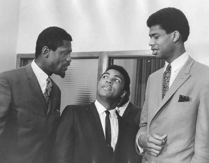 At a meeting of the Negro Industrial and Economic Union organized by football great Jim Brown, a group of top African American athletes from different sporting disciplines gathered to give support and hear the boxer Muhammad Ali give his reasons for rejecting the draft during the Vietnam War, Cleveland, June 4, 1967. Left to right, basketball player Bill Russell, boxing champ Muhammad Ali, and basketball player Kareem Abdul Jabbar. (Photo by Robert Abbott Sengstacke/Getty Images)