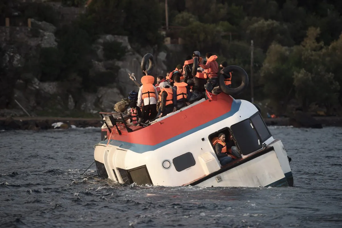 Refugees and migrants call for help as their boat sinks off the Greek island of Lesbos after crossing the Aegean sea from Turkey on October 30th, 2015. Following a rash of deadly shipwrecks in recent weeks which claimed the lives of hundreds of people, the UN refugee agency said the number of deaths at sea had risen sharply this year, with a record 2,814 people drowning since January. (ARIS MESSINIS/AFP/Getty Images)