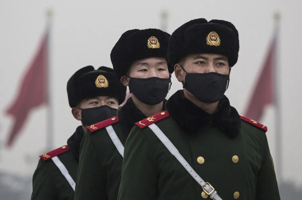 Chinese paramilitary police wear masks in Tiananmen Square on Dec. 9, 2015, in Beijing, China. Chinese state hackers are at the root of recent cyberattacks on the global banking system. (Kevin Frayer/Getty Images)