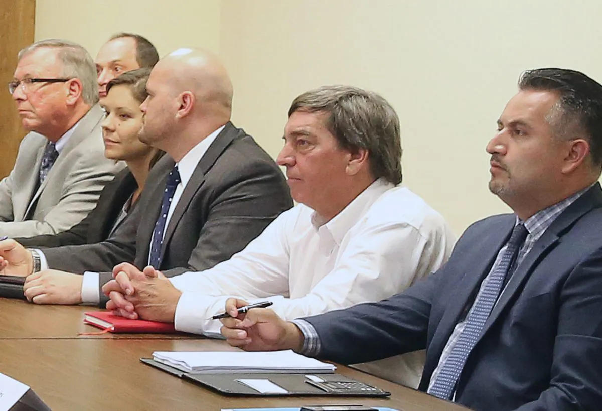 In the photo taken, Aug. 12, 2014, Jason Peltier, second from right, the former deputy general manager of the Westland Water District attends a water conference held by Gov. Jerry Brown at the Capitol in Sacramento, Calif. Peltier received a $1.4 million loan from the water district to buy a home in 2007 and has until 2021 to repay the final $1 million-plus. Experts in governance say the deal raises red flags, not just over the unpaid loan and its generous terms but over whether Peltier and Westlands complied with laws mandating disclosure of the use of public funds. (AP Photo/Rich Pedroncelli)