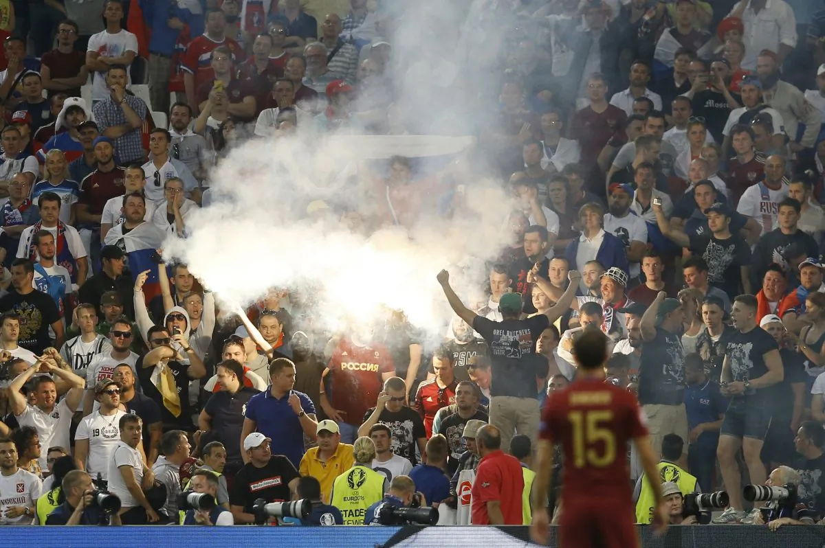 Flares are lit on the stands after Russia scored a goal during the Euro 2016 Group B soccer match between England and Russia, at the Velodrome stadium in Marseille, France, Saturday, June 11, 2016. (AP Photo/Kirsty Wigglesworth)