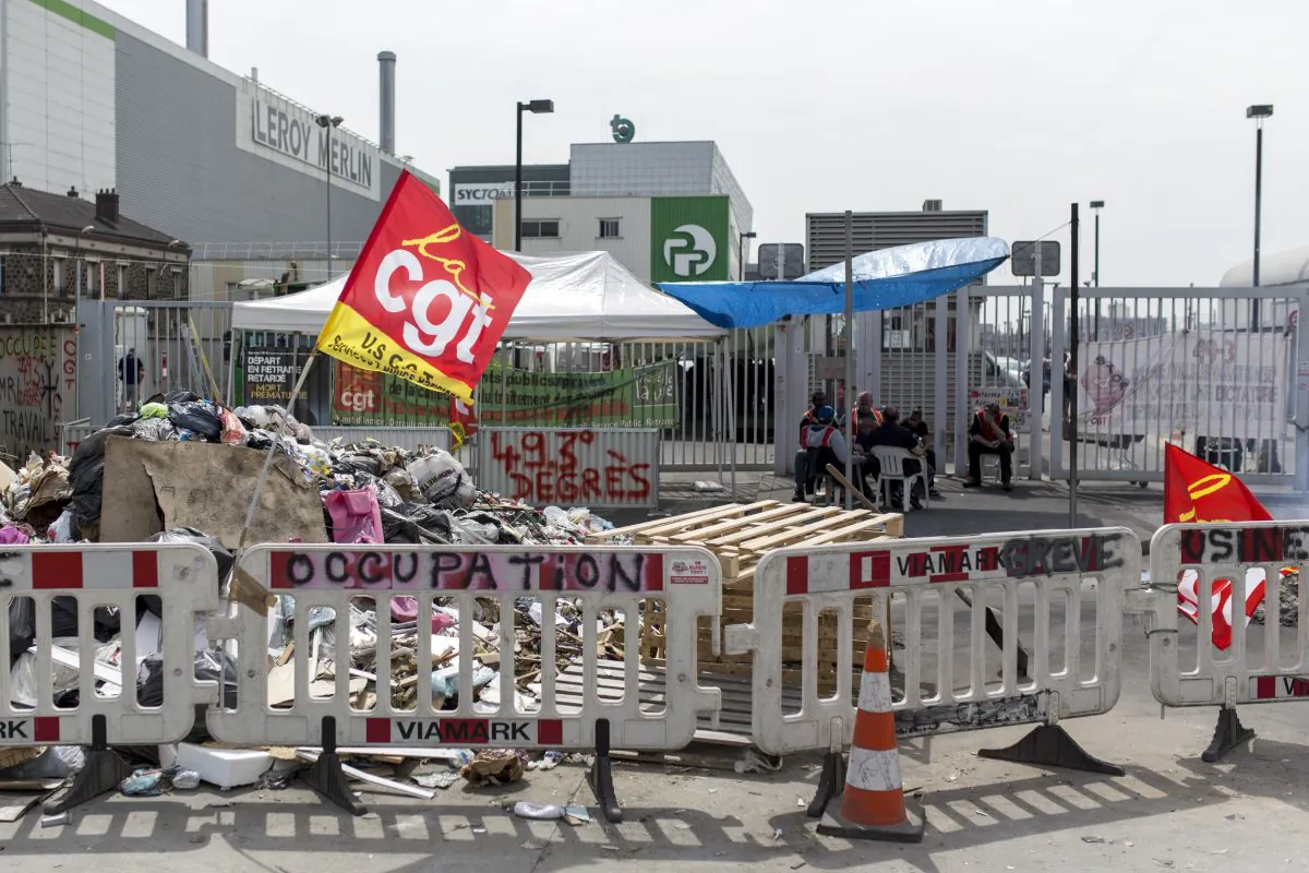 French striking CGT labour Union garbage collectors block access to the Paris waste treatment center in Ivry Sur Seine, near Paris, France, on June 10, 2016. The Paris mayor is promising to clear all city streets of garbage after 12-days of strikes, and further clouded France's image as it hosts the European Championship soccer tournament. (AP Photo/Kamil Zihnioglu)