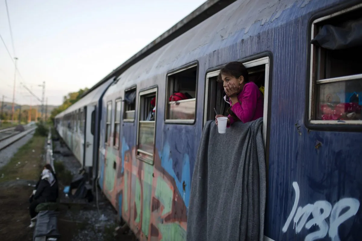 A Syrian girl looks out train window that she lives with her family in the sprawling refugee and migrant tent city of Idomeni, on Greece's northern border with Macedonia, on May 7, 2016. The evacuation of Idomeni has dashed the dreams of thousands migrants and refugees who had been camping there for months in the hopes of eventually being able to cross over the border and continue toward Europe's more prosperous heartland.(AP Photo/Petros Giannakouris)