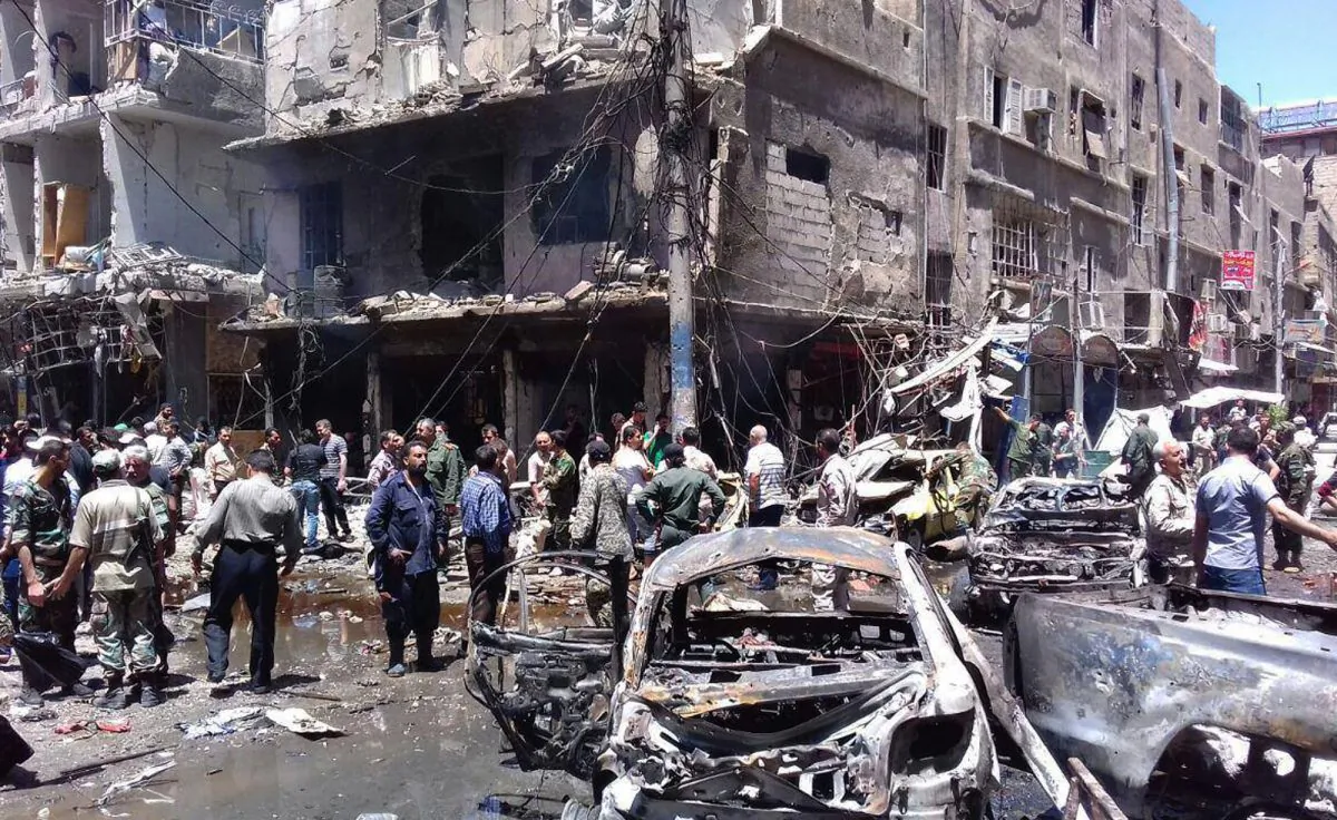 Syrians gather around damaged buildings after a bombing attack at the Sayyida Zeinab suburb, Damascus, Syria, on June 11, 2016. Two bombs went off Saturday near the Syrian capital, killing at least eight people and wounding over a dozen others in the latest attack to hit the predominantly Shiite area in recent months, state TV and an opposition activist group said. (SANA via AP)
