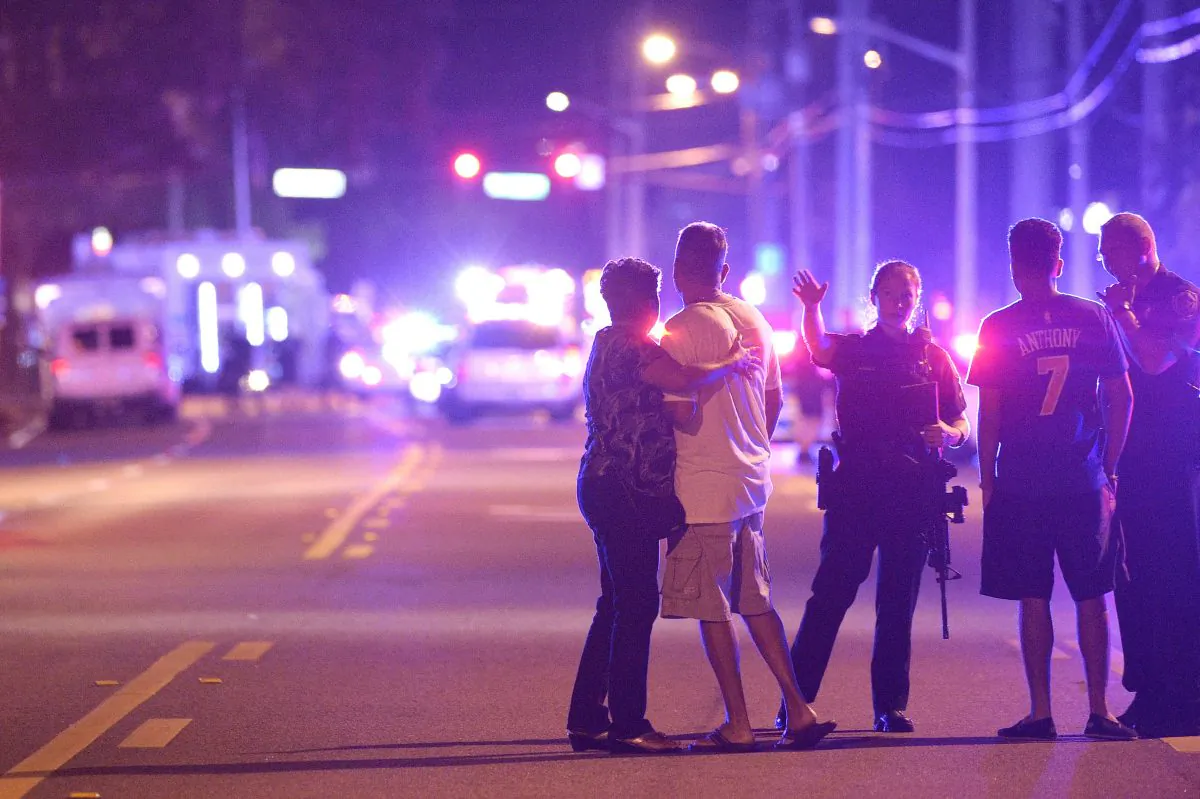 Orlando Police officers direct family members away from a fatal shooting at Pulse Orlando nightclub in Orlando, Fla., on June 12, 2016. (AP Photo/Phelan M. Ebenhack)