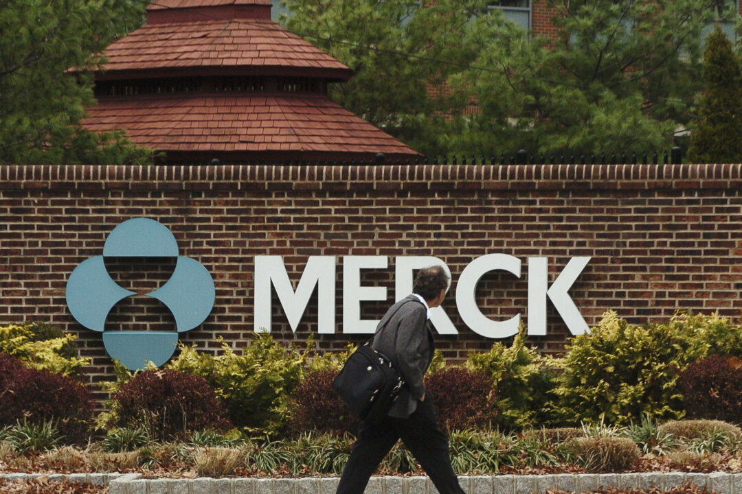 A man walks by a sign at a Merck plant in Rahway, N.J., on Nov. 29, 2005. (Marko Georgiev/Getty Images)