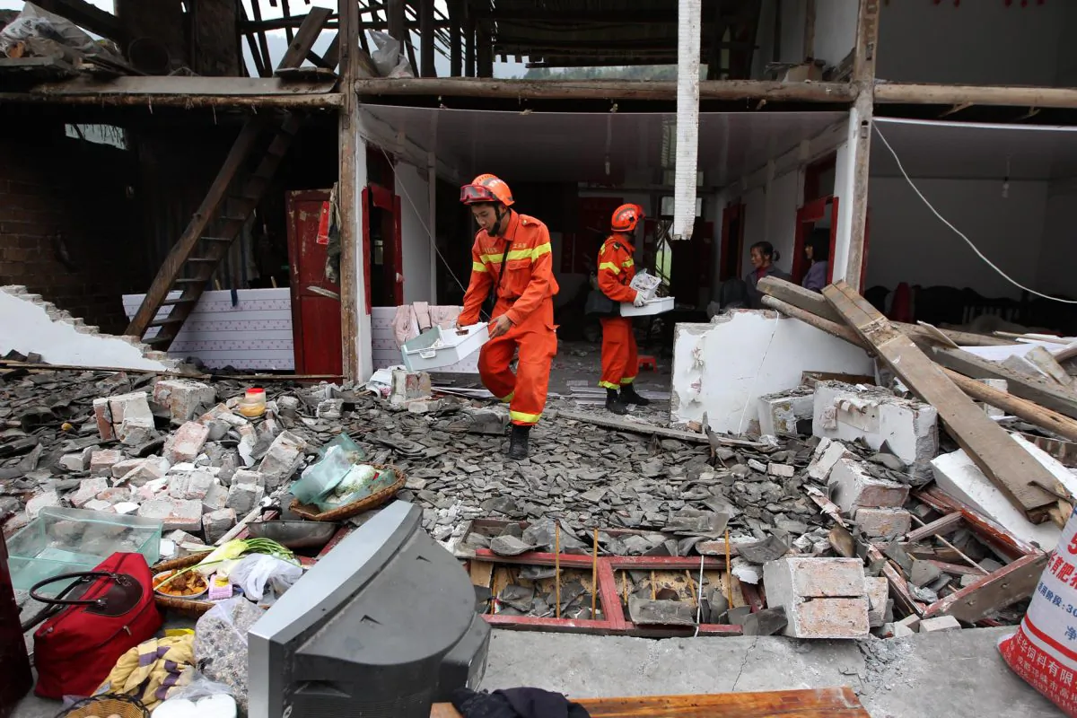 Rescuers help recover valuables from a damaged home after an earthquake hit Lushan County in Ya'an City, southwest China's Sichuan Province, on April 21, 2013. (STR/AFP/Getty Images)