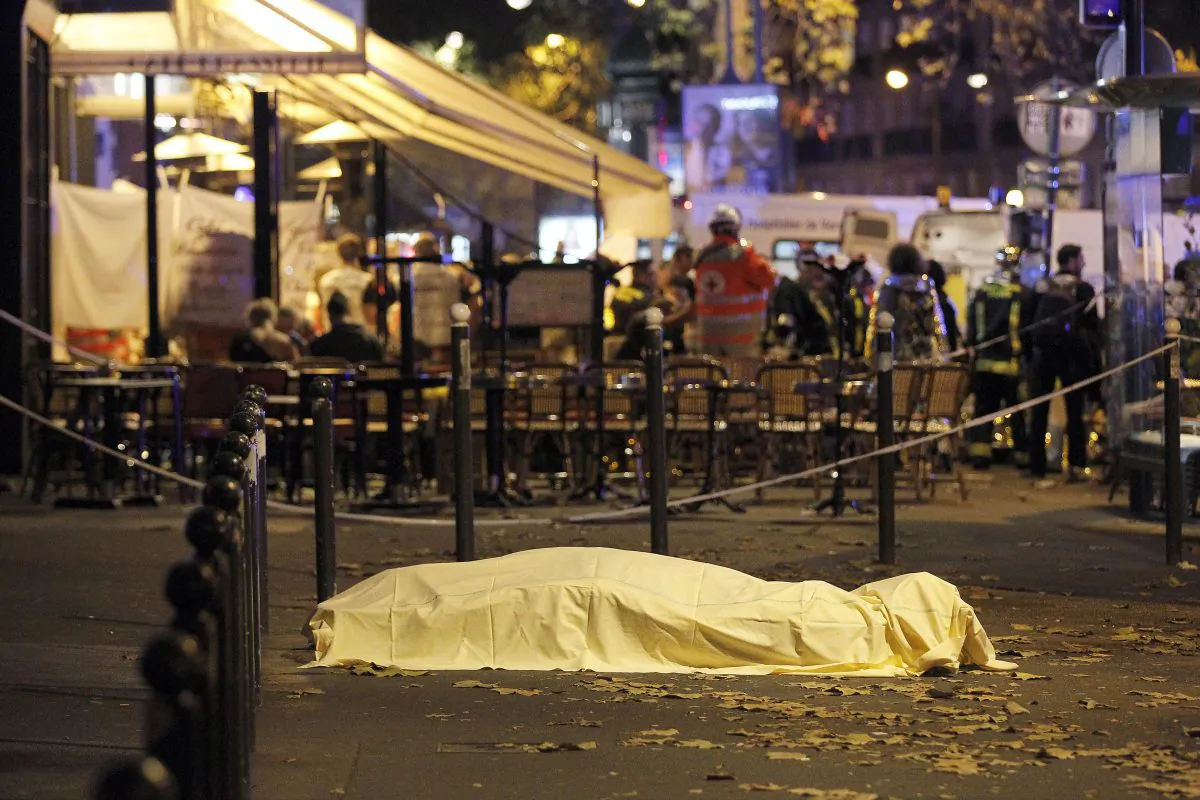 A victim's body lies covered on Boulevard des Filles du Calvaire, close to the Bataclan theater, in Paris, France, on Nov. 14, 2015. According to reports, over 150 people were killed in a series of bombings and shootings across Paris, including at a soccer game at the Stade de France and a concert at the Bataclan theater. (Thierry Chesnot/Getty Images)