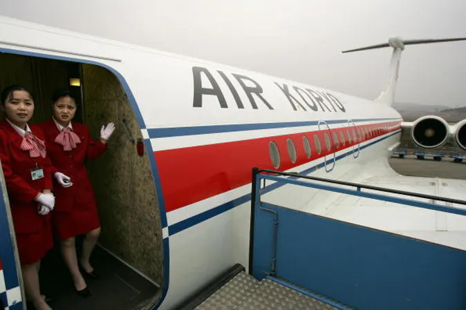 Pyongyang, DEMOCRATIC PEOPLE'S REPUBLIC OF: (FILES) - Picture taken 02 April 2005 shows air hostesses on Air Koryo, the North Korean airline waiting for passengers at Pyongyang International airport. Acting in response to a series of civil aviation disasters, France early monday published a list of five airlines banned in its airspace for safety reasons, including four already known plus a Thai company. AFP PHOTO/Peter PARKS (Photo credit should read PETER PARKS/AFP/Getty Images)