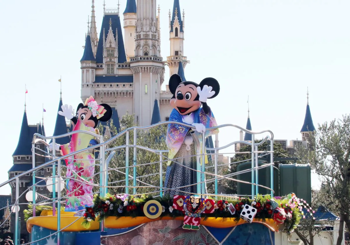 Disney characters Mickey (C) and Minnie Mouse (L), dressed in traditional Japanese kimonos, wave to greet guests from a float during the theme park's annual New Year's Day parade at Tokyo Disneyland in Urayasu, suburban Tokyo on January 1, 2016. The time around New Year's Day is one of the biggest holiday periods every year in Japan.      AFP PHOTO / Yoshikazu TSUNO / AFP / YOSHIKAZU TSUNO        (Photo credit should read YOSHIKAZU TSUNO/AFP/Getty Images)